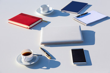 Selection of Business Items on White Table Outdoor Bright Sunlight