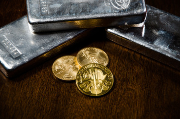 Dramatic Gold Coins & Silver Bars on Wooden Table