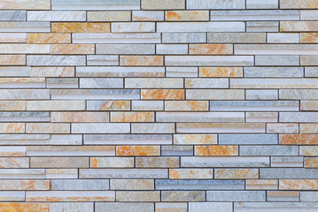 Texture and seamless background of brown granite stone block wall..