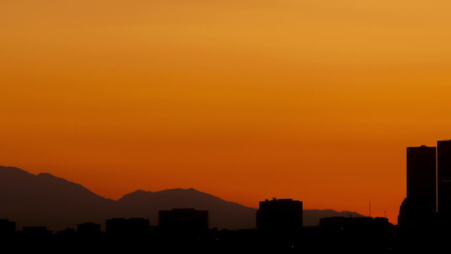 Time lapse close up pan shot Los Angeles skyline sunrise
