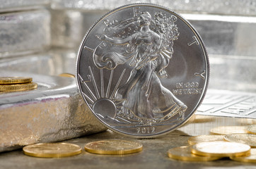 United States Silver Eagle with Gold coins & silver bars in back