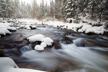 cold water of north river, russian nature, snowy river, river with snowy stones