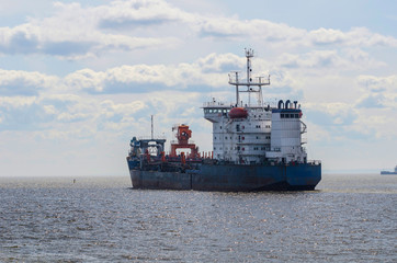 Cargo ship sailing in still water.