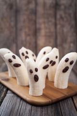 Scary halloween banana ghost chocolate faces healthy natural