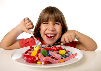 child eating candy like crazy in sugar abuse and unhealthy sweet nutrition concept