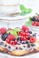 delicious pie with summer berries and mint on white background