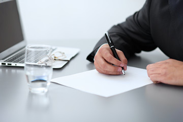 Close-up of male hands with pen over document,  business concept