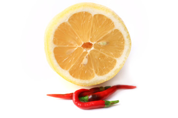 lemon and red hot peppers isolated on white background