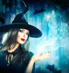 Halloween Witch holding magical light in her hand