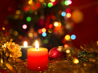 Christmas still life with candle and balls in red tone.