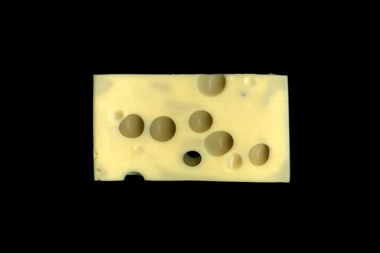 Emmental cheese with big holes, close up, on black background