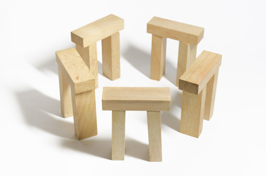 Isolated of wooden blocks sort to stonehenge on white background