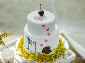 White wedding cake with gold rings