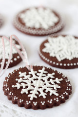 Decorating cookies with royal icing snow flakes.