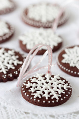 Decorating cookies with royal icing snow flakes.