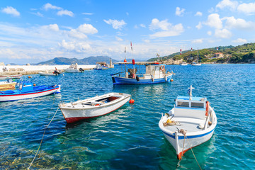 Traditional Greek fishing boats on blue sea in Kokkari bay, Samos island, Greece