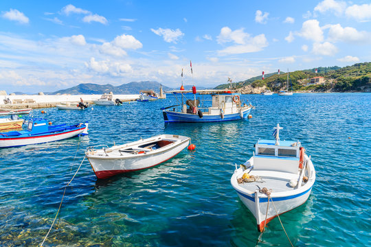 Traditional Greek fishing boats on blue sea in Kokkari bay, Samos island, Greece