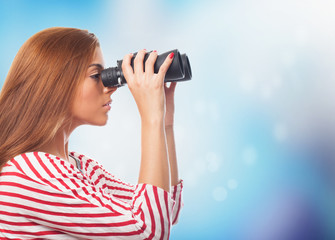 portrait of young woman looking throught a binoculars