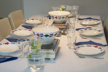 Table for dinner with plates and bowls