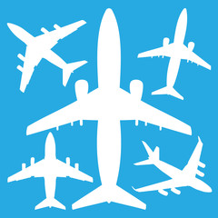white jet airliners in the air isolated on blue background