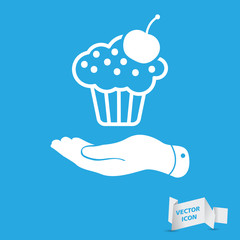 flat hand presenting white cake icon with cherry on a blue backg