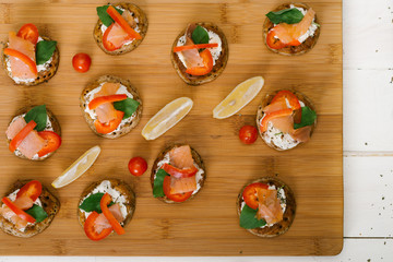 Blinis on the wooden table, Salmon sandwich .