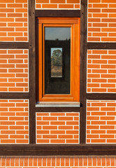 window on  brick wall with wooden structure