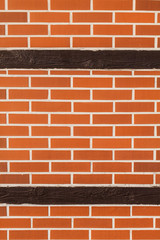 Obraz premium Background of brick wall with wooden post