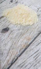 Grated cheese over wooden background