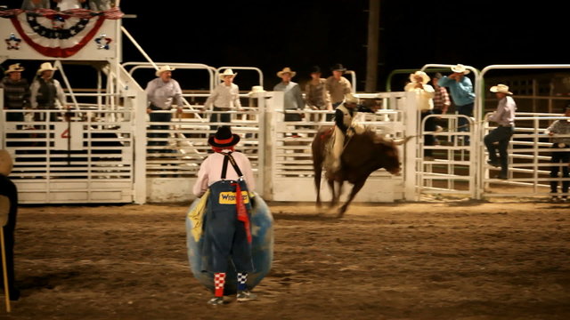 Bull rider stuck on bull at rodeo P HD 1002
