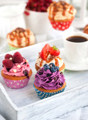 Different delicious cupcakes and coffee cup