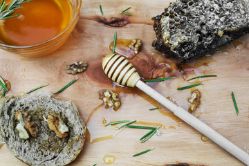 Jar with organic honey, honeycomb nut, walnut and rosemary leave