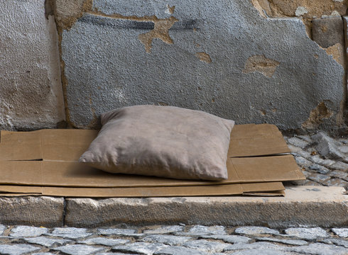 dirty pillow on a paper-box matrass in the strret of Lisbon