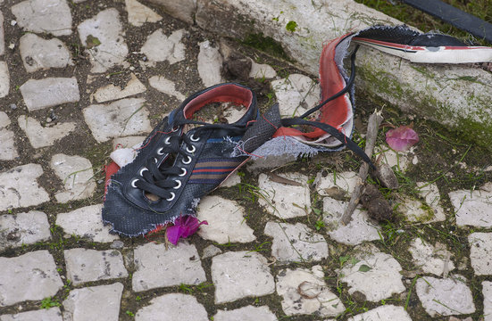 old broken sneaker abandoned in the street of Lisbon