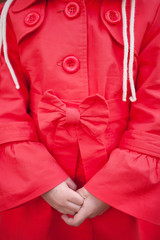 red coat with a bow on the girl