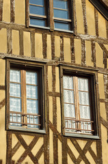 Windows in half-timbered house in Troyes, France .