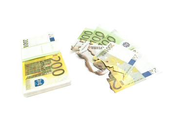 burned bills and euros on white