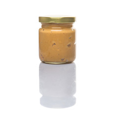 Peanut butter in a mason jar over white background