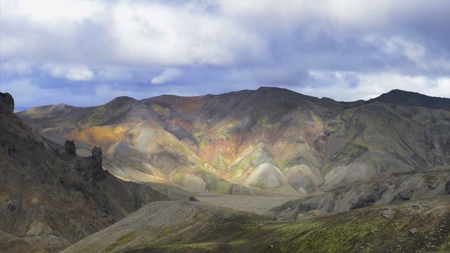 Clouds moving over the colorful mountains of the Landmannalaugar area in Iceland.