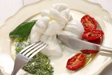 burrata, fresh italian cheese made from mozzarella and cream.
