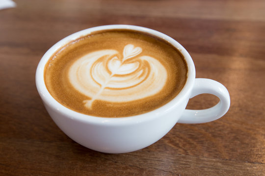 art latte coffee on white cup