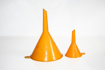 A pair of two orange funnels. Big and small. Isolated on white with clipping path.