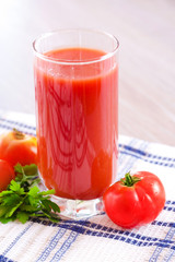 Glass of fresh tomato juice on the table