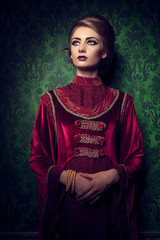 Aristocratic woman in vintage clothes on rococ period pattern