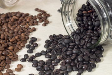 Torrefacto coffee beans beside natural roasted coffee beans