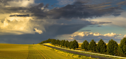 Storm clouds over country road