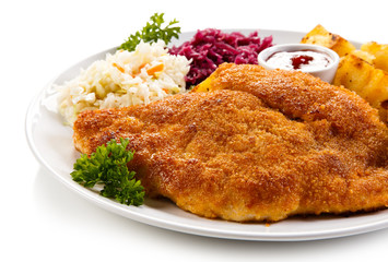 Fried pork chop, baked potatoes and vegetable salad 