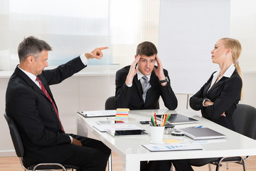 Businessman Arguing With His Two Co-workers