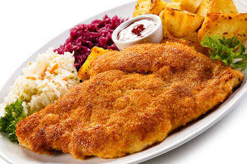 Fried pork chop, baked potatoes and vegetable salad 