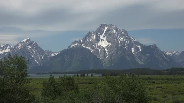 Grant Teton Mountain range meadow lake glacier 4K. Grand Teton National Park northwestern Wyoming directly south of Yellowstone. At approximately 310,000 acres.
